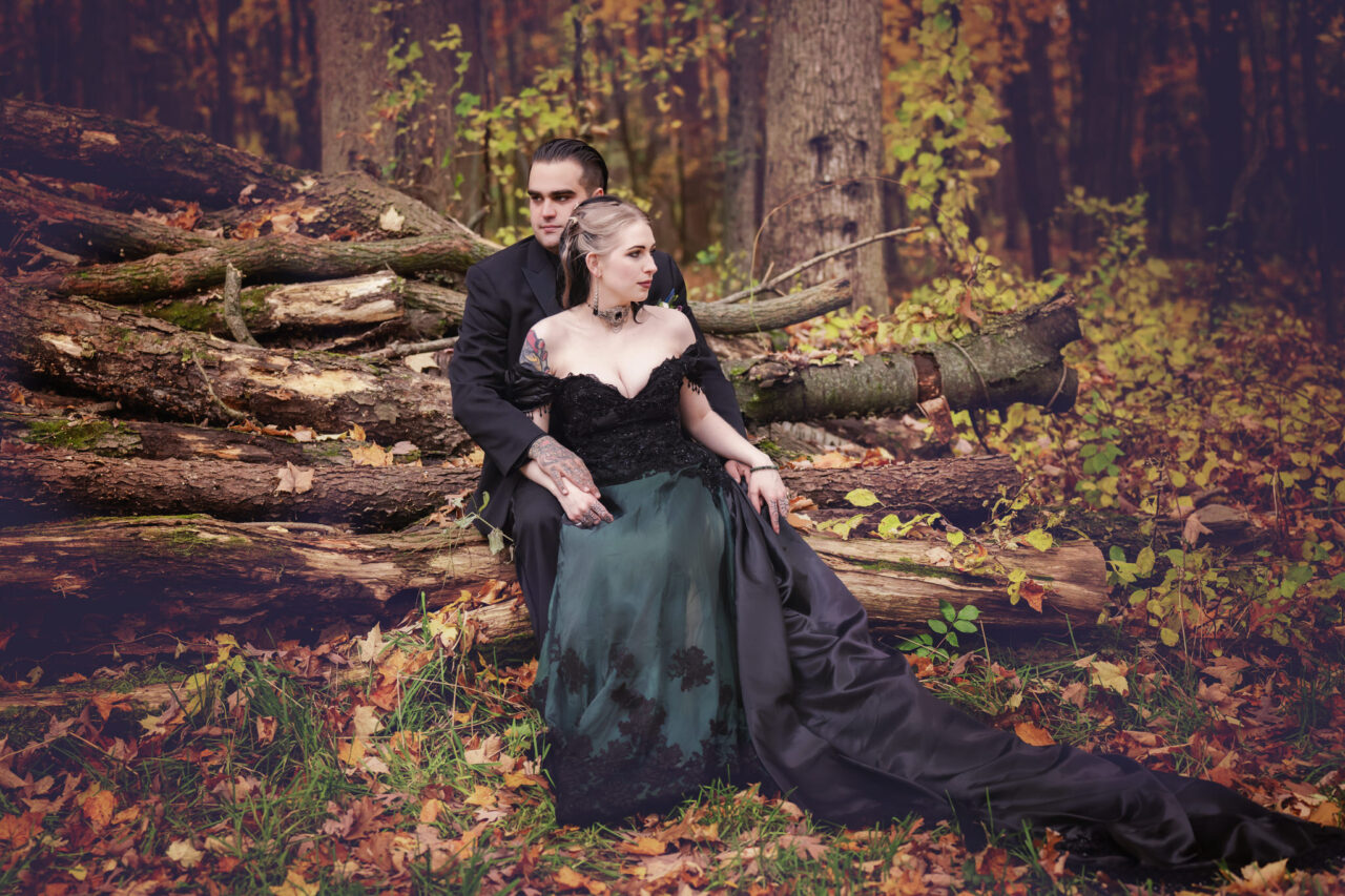 A dramatic fall portrait of a bride and groom in black